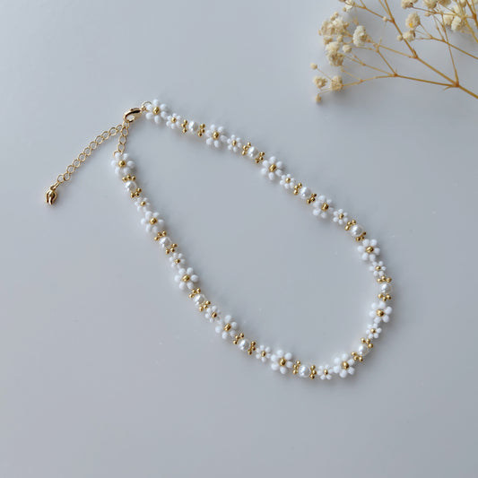 Handmade beaded pearl necklace with 2mm and 3mm seed beads on a white background