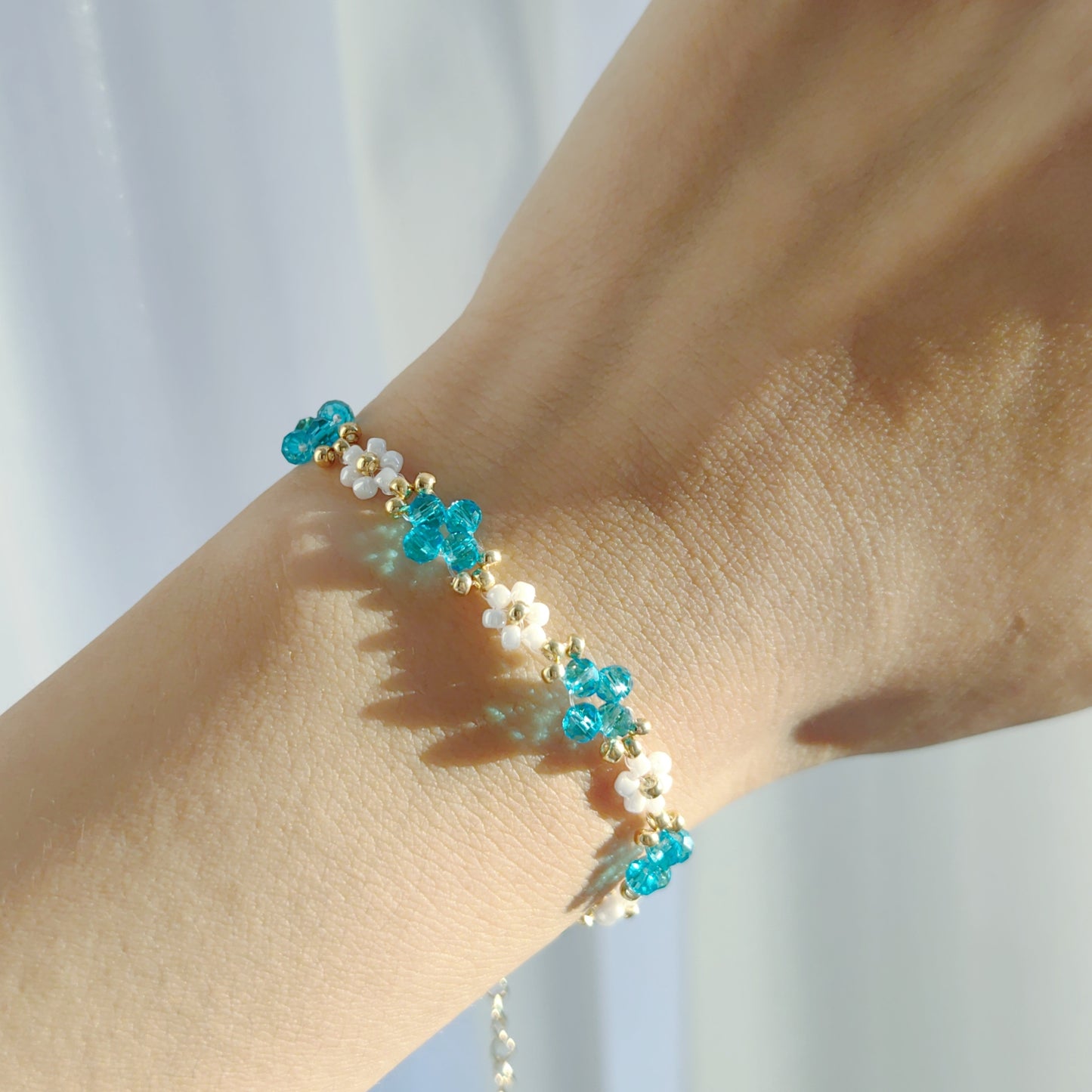 Lake blue Crystal & White Seed Bead Bracelet worn on wrist