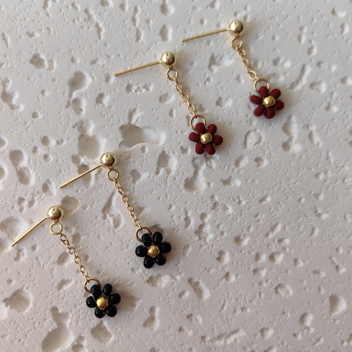 Black and red Daisy Earrings displayed on board, handmade 3mm seed bead floral earrings