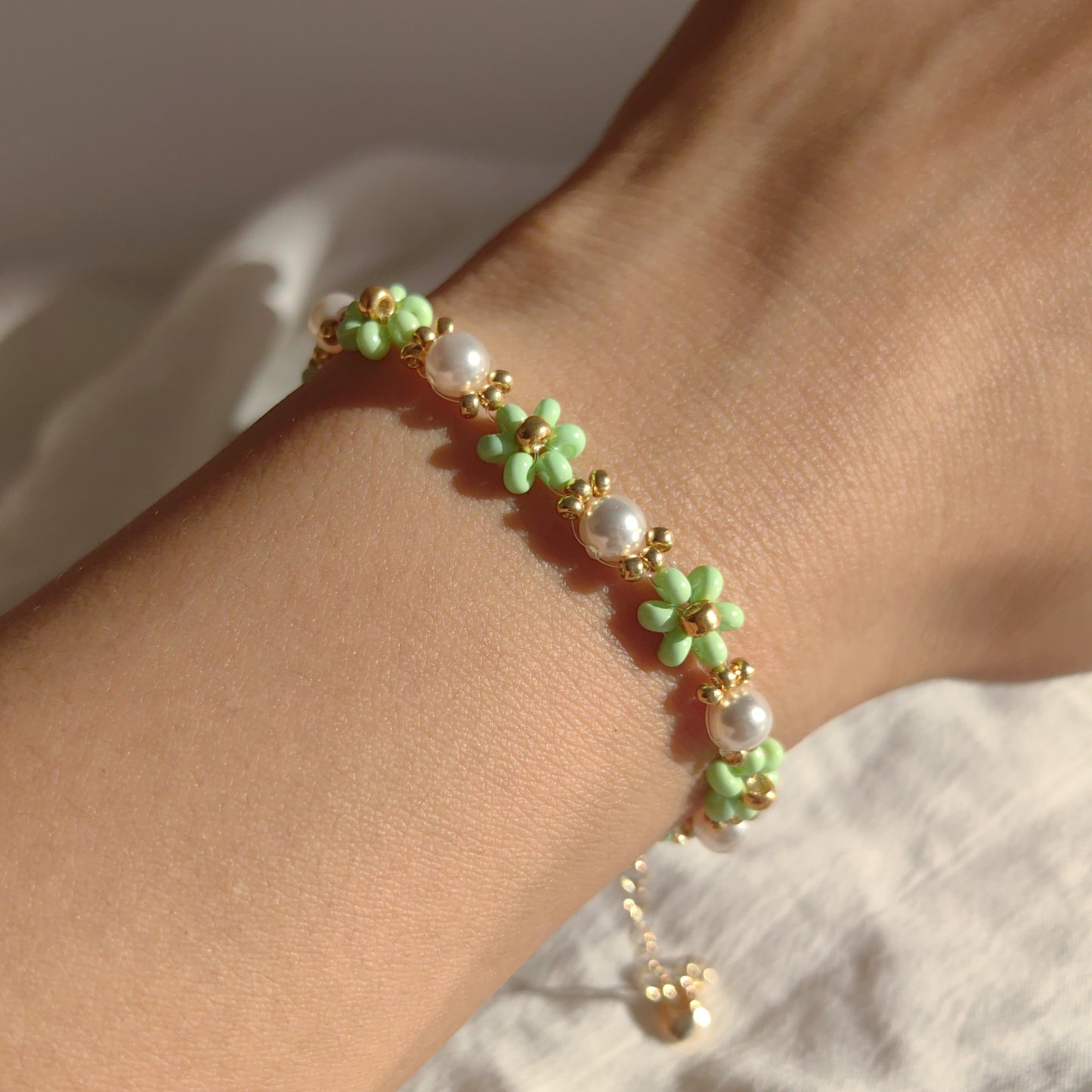 Green Pearl Blossom seed bead and pearl bracelet worn on hand