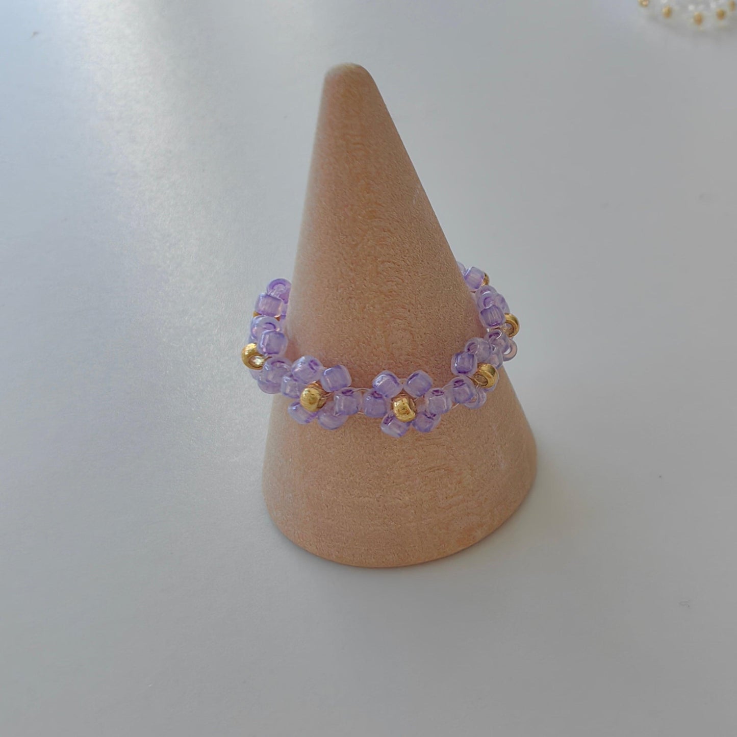 Purple Fairytale 2mm seed bead ring on ring stand