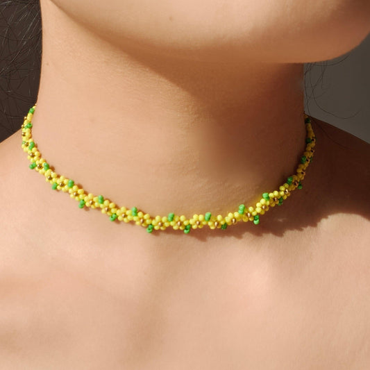 Handmade sunflower beaded necklace worn on neck with yellow and green seed beads