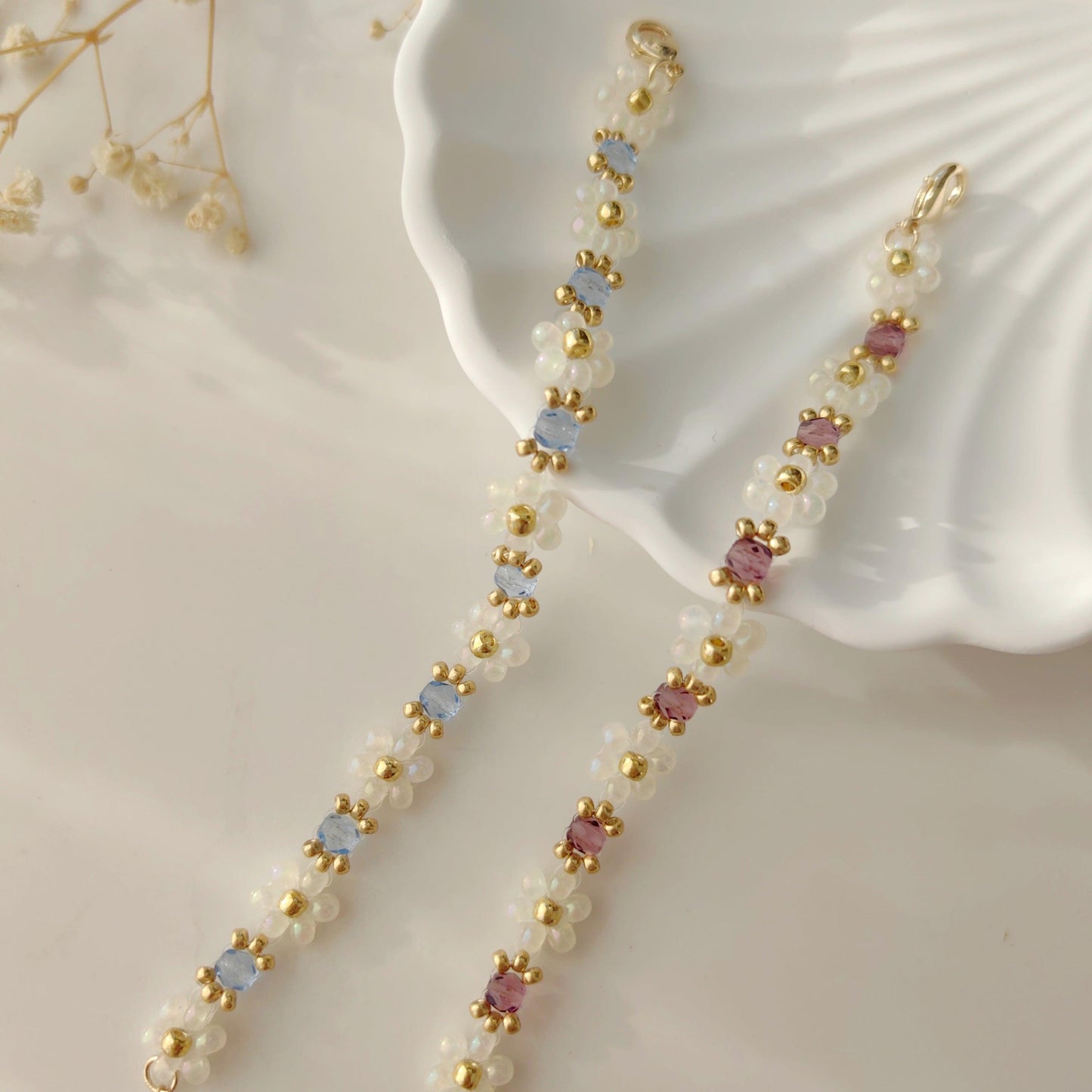 White seed bead crystal bracelets in blue and purple shown on white plate