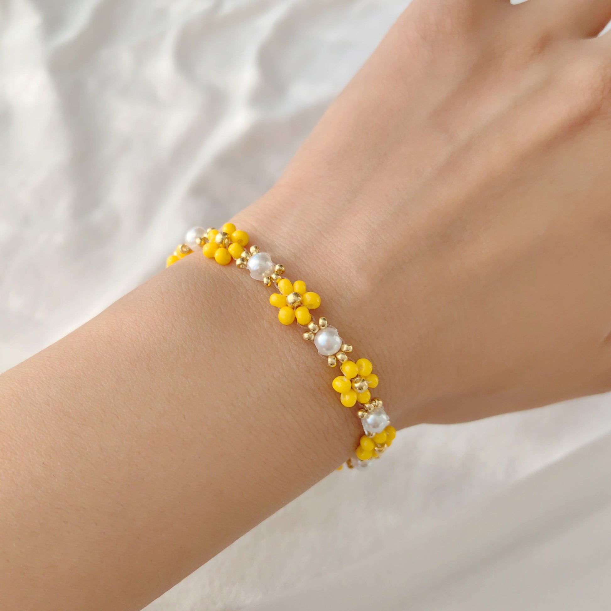 Yellow Pearl Blossom seed bead and pearl bracelet worn on wrist