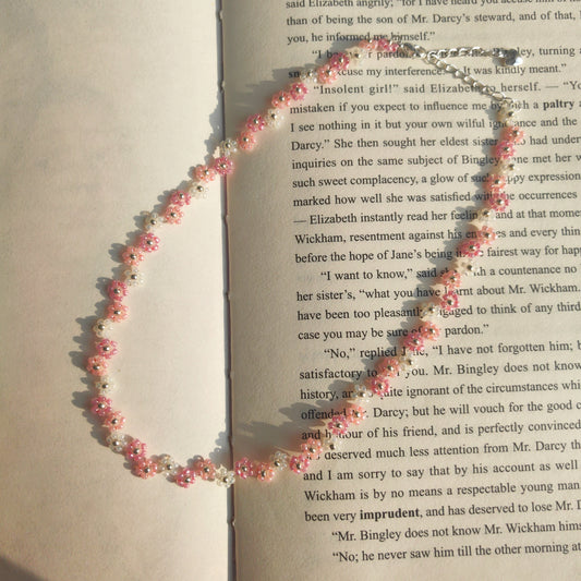 Handmade zigzag fairy beaded necklace with purple blue and white seed beads on newspaper background