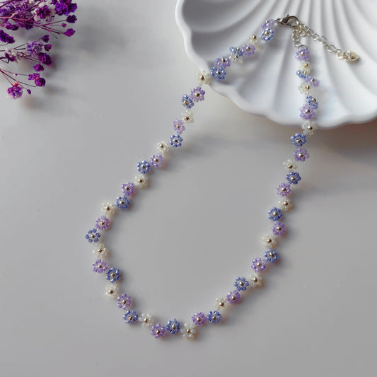 Handmade zigzag lavender beaded necklace with purple blue and white seed beads on white plate